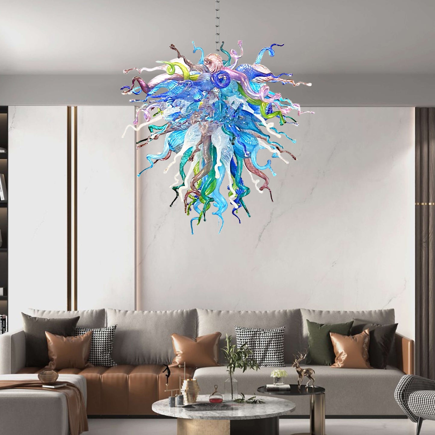 Colorful glass chandelier hanging above a modern living room with a sofa and coffee table.