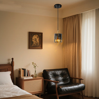 Modern 1-light mini pendant light with smoke gray textured glass hanging beside a bed in a cozy bedroom
