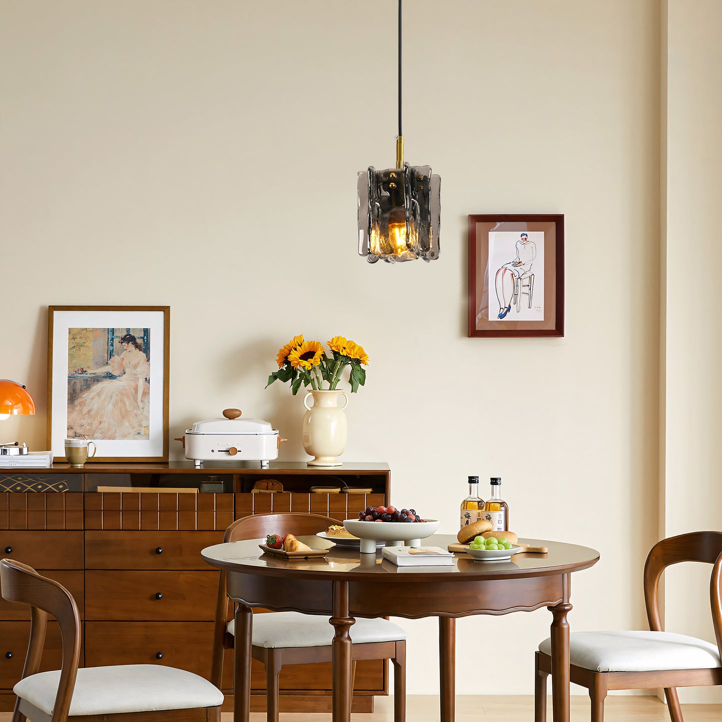 Modern 1-light mini pendant light with smoke gray textured glass above a round dining table