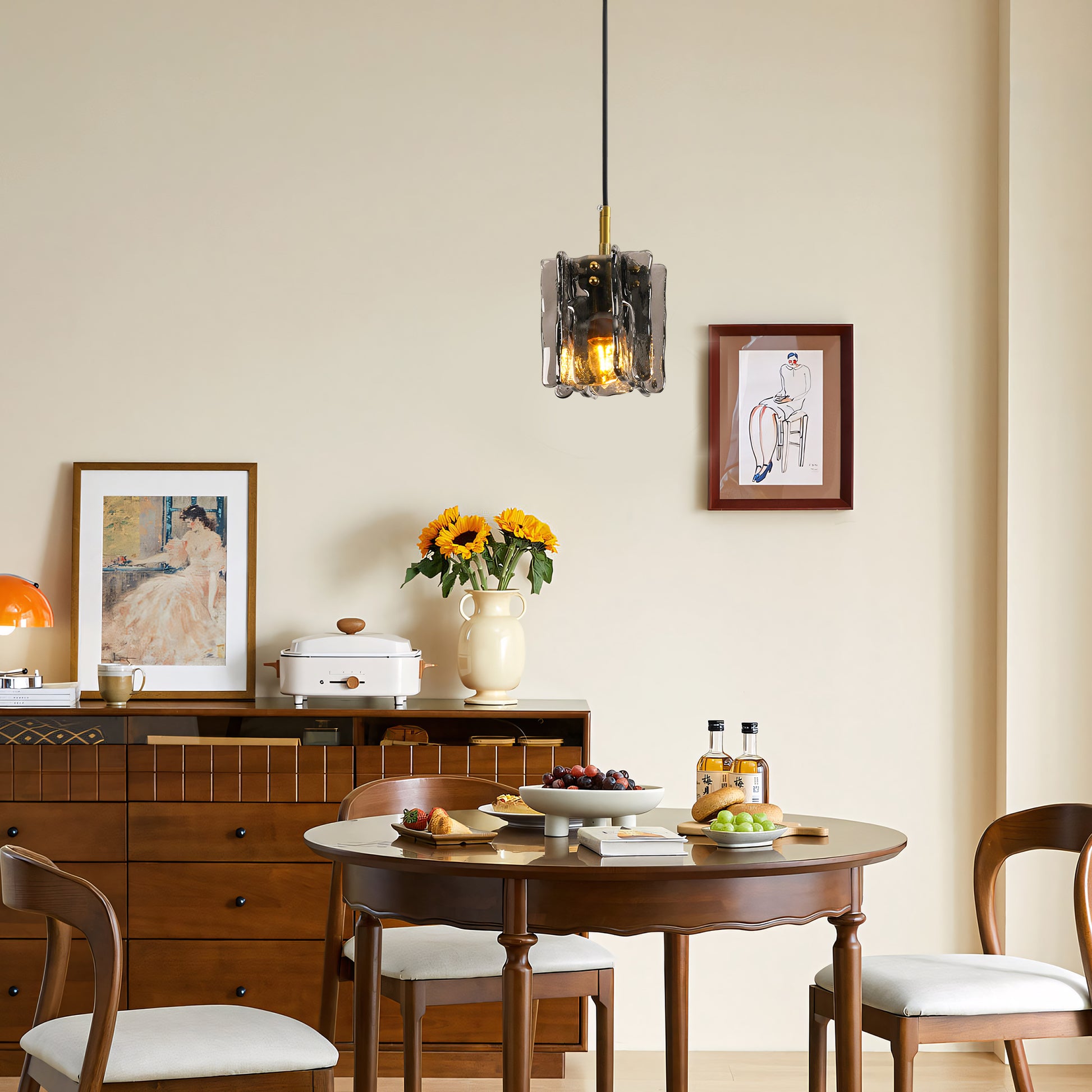 Modern 1-light mini pendant light with smoke gray textured glass above a round dining table